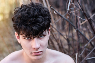 The teenage boy is resting in the park from the hustle and bustle of the city and calms down after...