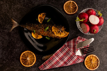 baked fish in citrus fruits