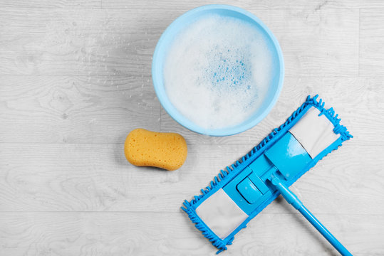 Mopping, Blue Wet Microfiber Mop With Detergent. Cleaning Disinfection Kit On A White Floor Isolated. Housekeeping Concept