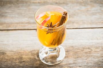 Healthy hot beverage with oranges, apples and spices for protection in flu season. Selective focus. Shallow depth of field.