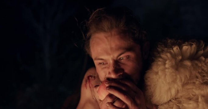 Scared man eating apple at night