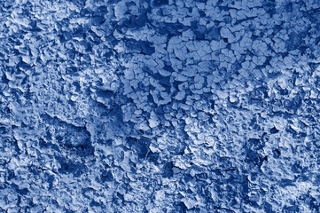 Fototapeta na wymiar Blue background of a peeling wall. The fashion trend of the year is classic blue. Abstract texture, Wallpaper.