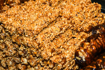 Cevizli sucuk made by dipping a string with walnuts into a grape molasses mixture