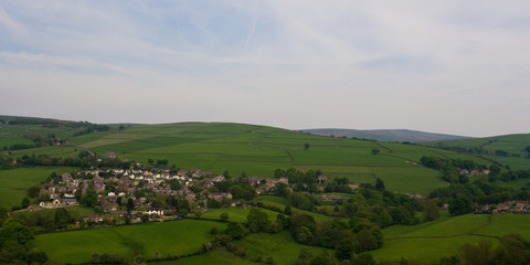View of small rural British village and surrounding hills from a distance