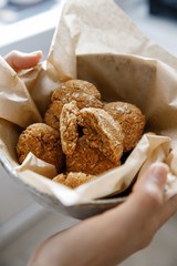 plate of cookies in heands on parchment paper