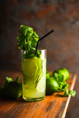 Mojito cocktail with lime and mint on the rustic background. Selective focus. Shallow depth of field.