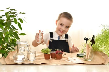  The smiling kid took aim at the spray. Care for micro greens in pots. Spraying from a spray bottle.