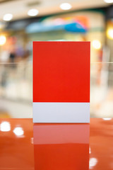 Mock up menu acrylic stand for advertisement sales and marketing strategy prices produce and products, blank canvas space for logo and graphics in shopping mall center public area with background blur
