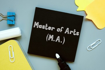 Business concept meaning Master of Arts M.A. with phrase on the sheet.