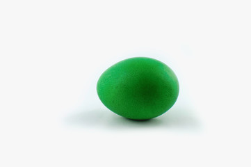 Green easter egg isolated on white background, colored by easter bunny