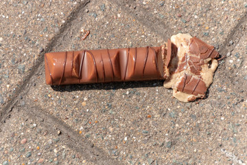 a close up view of a bar of chocolate that has been dropped and squashed on the one side