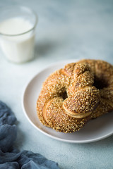 Freshly baked bagel bread on white plate. Selective focus