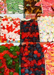 Colorful multicolored dragee, chocolate covered nuts drops. fruit sauce