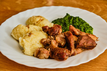 Roasted pork meat with furry dumplings and spinach