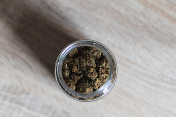A Jar With Weed On Wooden Background