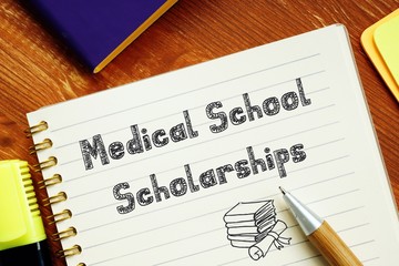 Medical School Scholarships sign on the piece of paper.