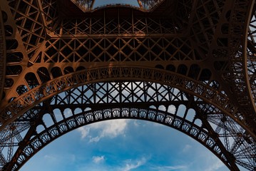 View from beneath Eiffel Tower with blue sky background
