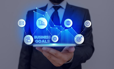 Conceptual hand writing showing Business Goals. Concept meaning Expectation to accomplish over a...