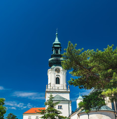 Nitra Castle located in Old Town of Nitra, Slovakia. Main entrance, Tower of Castle with clock under blue sky in beautiful summer day