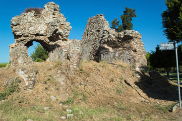 The walls of an ancient building in the city center of Side. The antique ruins near a Child park. Sights and tourist places in the Turkish city.