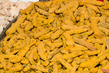 Dried turmeric (curcuma) and dried ginger root background for sale in Istanbul grand bazaar market....