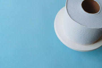 Roll of toilet paper on a pastel blue background coronavirus design