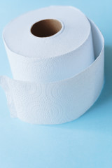 Roll of toilet paper on a pastel blue background coronavirus design
