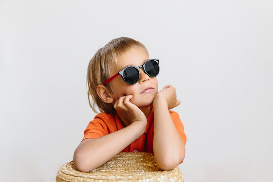 cute baby boy with sunglasses on white background, summer vacation concept