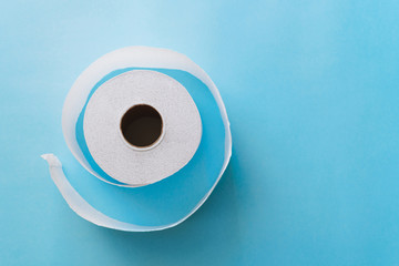 Roll of toilet paper on a pastel blue background coronavirus design