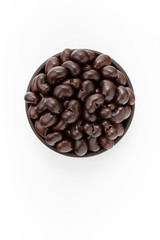 Chocolate Cashew nuts in round bowl on white background, top view