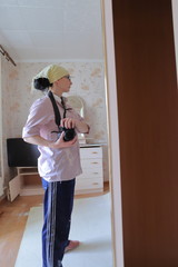 a plasterer-painter in working clothes, a girl taking pictures of herself in the mirror before repairs, a worker finishing apartments