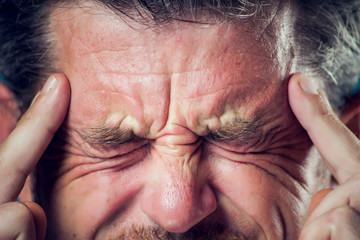 Fototapeta premium A man feeling headache. Close up. People, healthcare and medicine concept.