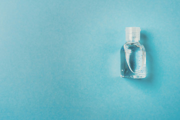 antibacterial gel bottle on a teal blue background. Prevent the coronavirus. Protection concept