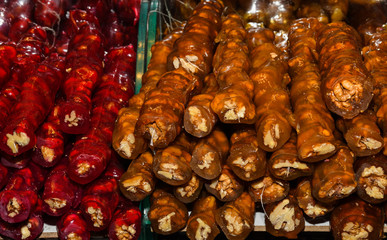 Cevizli sucuk made by dipping a string with walnuts into a grape molasses mixture