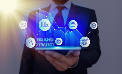 Conceptual hand writing showing Brand Strategy. Concept meaning Long term marketing support for a product Marketing