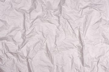 Crumpled gray paper texture. Wrinkled paper background with cracks and kinks.