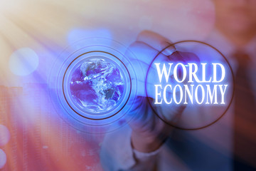 Writing note showing World Economy. Business concept for Global Worldwide International markets trade money exchange Elements of this image furnished by NASA