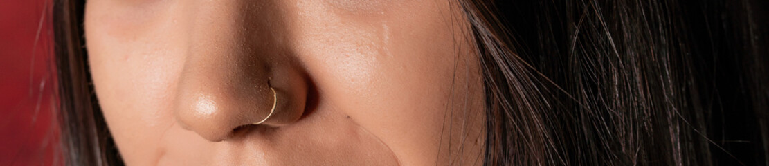 Close up of young woman with nose piercings
