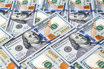 One hundred dollar bills background. A pile of American dollars banknotes. The texture of the money.