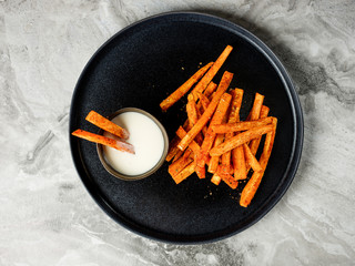 Top view Sweet potato sticks chips appetizer snack served with white sauce. Vegetarian diet and healthy food concept. - 347228812