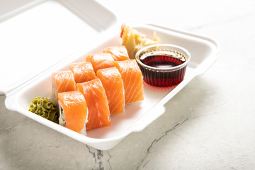 Box with rolls Philadelphia soy sauce and wasabi. Japanese kitchen. Food delivery.