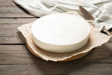 Tasty homemade cheesecake on a wooden background. Place for text.