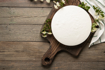Tasty homemade cheesecake on a wooden background. Place for text.