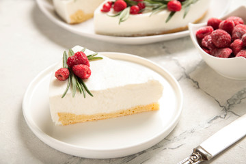 A slice of cheesecake with raspberries on a plate. Close-up.