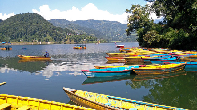 small colored Nepalese boats for tourists on Lake Begnas near Pokhara in the Nepali Himalayas