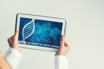 Close of female doctor hands working with tablet pc computer