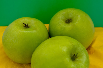 green apples on a yellow background