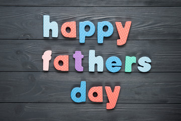 Text happy dad's day on a gray wooden background