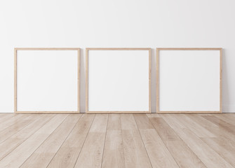 Three wooden square frames Standing on parquet floor with white background, minimal frame mock up interior 