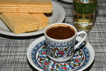Obraz na płótnie Canvas Coffee in metal Turkish traditional cup, being served in a traditional cafe bar in Istanbul, Turkey